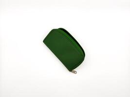Small green fabric wallet with zipper on white background. copy space, flay lay, top view photo