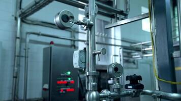 Milk production at a dairy factory. Metal pipes and new technology tubes inside a milk farm. Automated equipment on dairy factory. video