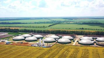Biogas complex on green nature background. Renewable energy. Modern plant for production of biogas on field. Aerial view. video