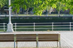 A bench sitting on a sidewalk photo