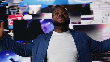 Black guy immersed in a world of screens and online content, representing the future of social engagement, AI driven platforms and interactive digital experiences. User interface. Camera B. video