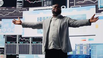 Young black administrator leads visionary business pitch at event, inspiring the audience to increase performance metrics. Businessman public speaker doing a speech at the convention. Camera B. video