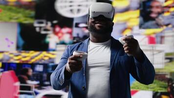 Black male expert uses high tech VR glasses for mobile feeds, showcasing engagement with digital presence, communication and interaction through application. Modern devices and platforms. Camera B. video