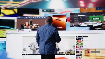 Smiling user navigating through online content and mobile apps, surrounded by visual elements of social engagement, tech communication and modern digital platforms on smartphone. Camera A. video