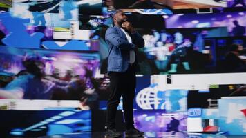 African American digital creator using dashboards with dynamic screens showcasing social media and networking, highlighting the importance of online engagement and global connection. Camera A. video