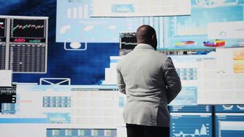 Modern business manager thinking about new successful ideas to increase his profit and develop the company, using insight and KPI projections or models for strategic decision making. Camera A. video