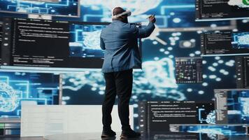 Digital tech expert coding and using VR headset at innovation hub, showcasing the intersection of data science and cybersecurity. Coding life immersed in high tech code development. Camera A. video
