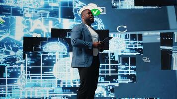 Black public speaker host presenting AI neural networks at live event, sharing insight on machine learning and predictive analytics. Young engineer presenter at tech convention. Camera A. video