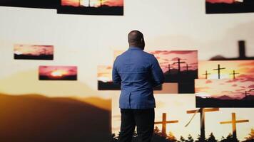 Black person does meditation pose with hands together in prayer, radiating inner peace and spiritual devotion. Surrounded by images of the cross, serenity and divine connection. Camera A. video