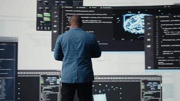 African american coder expert immersing in software development for a high tech work environment, focused on laptop screen. Engineer enjoying coding life and IT cloud computing. Camera A. video