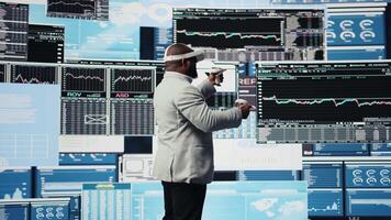 High tech startup entrepreneur using virtual reality glasses to examine KPI models, reviewing infographics and working on business productivity. Professional VR gadget simulation. Camera A. video