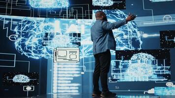 African american IT expert hosting a presentation with AI systems for the audience, talking on microphone about data visualization and machine learning algorithms. Public speaking concept. Camera A. video