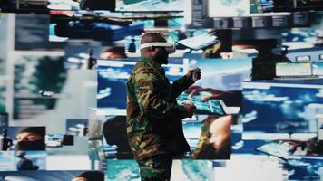 African american soldier uses virtual reality headset to monitor surveillance footage, using interactive device to guarantee successful national defense mission. War zone operations. Camera A. video
