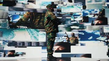 Officer monitoring real time combat data using advanced military systems, cyber tactics and digital surveillance to ensure battlefield control and strategic defense. War planning. Camera A. video