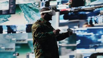 African american soldier uses virtual reality headset to monitor surveillance footage, using interactive device to guarantee successful national defense mission. War zone operations. Camera B. video