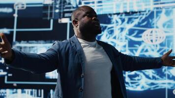 African american tech expert presenter speaking about AI at modern event, hosting a convention to offer insight on machine learning neural networks systems for the live audience. Camera B. video