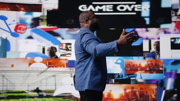 African american host at digital event engages the audience with insights on social media trends, e commerce and engagement using apps or web platforms. Real time data visualization. Camera A. video