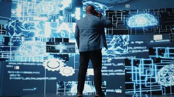 African american IT expert answers phone call to discuss deep learning through neural networks and automation systems. Chatting on telephone line for predictive analytics science. Camera A. video