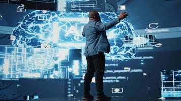 Black public speaker engineer presenting AI neural networks to the audience, discussing about the importance of automation and predictive analytics. Artificial intelligence convention. Camera A. video
