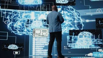 African american IT specialist ensuring futuristic AI brain in the background, machine learning through neural networks and cloud computing platforms. Algorithmic thinking. Camera A. video