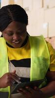 Vertical Satisfied coworkers sharing a high five after successful order processing, feeling proud of their teamwork in the industrial retail facility. Fulfillment center employees in workwear. Camera B. video