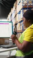 Vertical Woman staff managing package labeling using shipment details adhesive tags, handling order processing and preparing the packages for distribution. Online shopping fulfillment center. Camera A. video