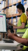 Vertical Warehouse supply and demand operations for package tracking, checking shipment details for fast delivery service. Handling merchandise registration for inventory control in big depot. Camera B. video