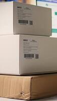 Vertical Logistics hub worker uses scanner on tracking info tags for express delivery, conducting order fulfillment for cargo goods distribution. Parcel tracking and barcode scanning, e commerce. Camera A. video