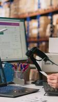 Vertical Staff employs software for order processing automation, advanced neural networks brain helps with tracking software in distribution hub. Warehouse with storage racks. Camera B. video