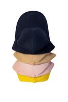 Yellow, blue, pink and beige cap, top view, isolated on white background. Four caps stacked one after another, mockup for logo placement. photo