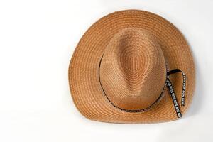 Summer straw sun hat for beach, pool, vacation on white background with space for text. Accessories and beach vacation concept. photo