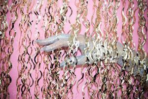 Glittering hand reaches through shimmering golden ribbons in vibrant setting. photo