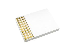 Reloading primers in a white box, isolated on white back photo