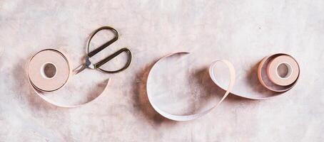 Beige special physical tapes for face and body on the table top view web banner photo