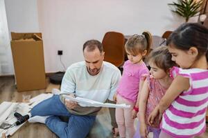 Dad and daughters enjoying creative bonding time at home photo