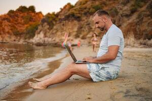Family enjoys a sunny beach day with a tech twist by the shore photo