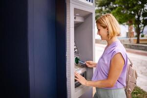 Enjoying summer in Greece while using an ATM machine photo