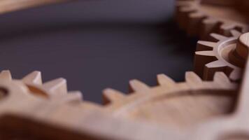 Looping animation of a mechanical construction made of wooden gears. Cyclic movement. Close-up. Horizontal composition. Defocus video