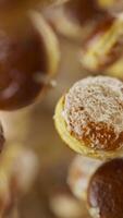 Animation of a group of donuts. Many donuts slowly rotate in the background in space. Vertical composition. Defocus. Close-up. video