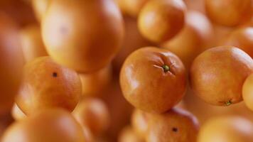 Animation of a group of mandarin. Many tangerines slowly rotate in the background in space. Horizontal composition. Defocus. Close-up. video