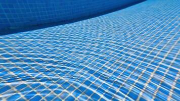 A vibrant underwater view showcasing a blue pool surface with a grid pattern, perfect for summer themes. video