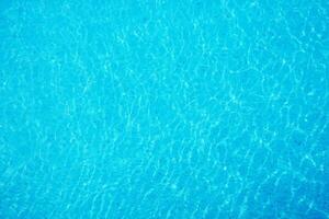 surface of ripple on blue water in swimming pool background. photo