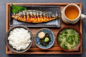 Grilled mackerel set meal served with rice, miso soup, and pickles photo