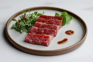 Exquisite michelin star beef appetizer with microgreens and soy sauce photo