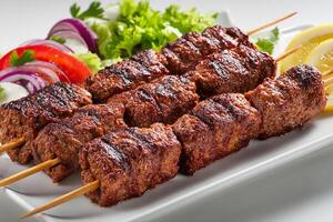 Delicious Turkish beef adana kababs with spices grilled on white background photo