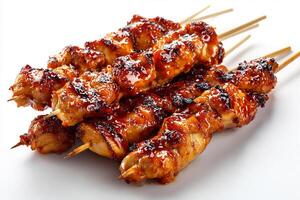 Tasty BBQ chicken skewers with glaze on white table photo