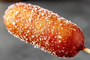 Crunchy Korean Corn Dog with Sugar Glaze Styled on Clean Background photo