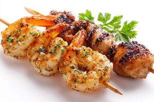Delicious grilled shrimp and chicken skewers with smoky char marks on white surface photo