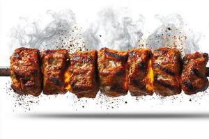 Juicy grilled kababs with charred smoky edges on white plate surface photo