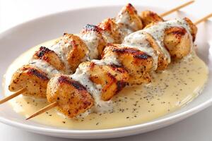 Tender chicken kababs grilled and served with rich creamy sauce and spices photo